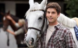 Young man looking after horses